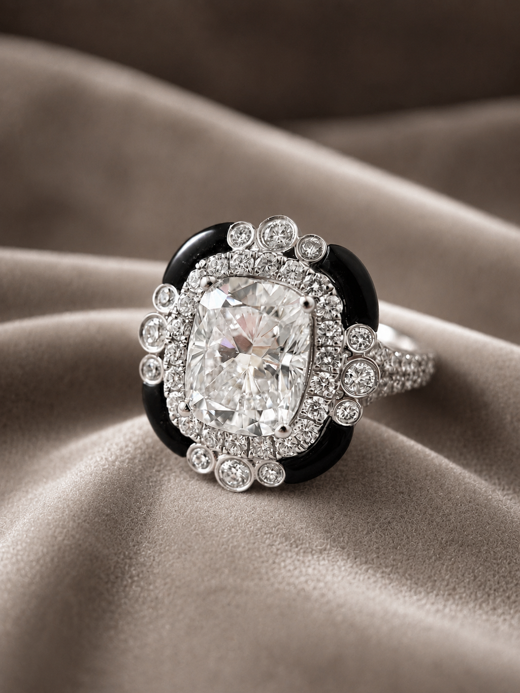 A luxury ring featuring a large cushion-cut diamond surrounded by a halo of small diamonds, set against a black enamel background and a diamond-encrusted band, displayed on draped beige satin fabric.